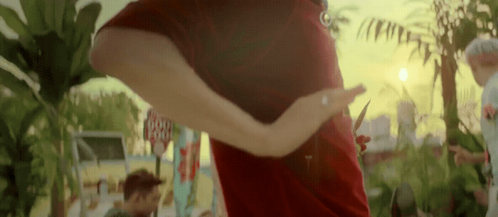 a man in a red shirt holding a pair of scissors
