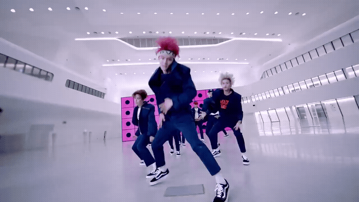 a group of people are dancing in a room