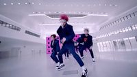 a group of people are dancing in a room