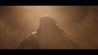 a blurry image of a man in a dark room