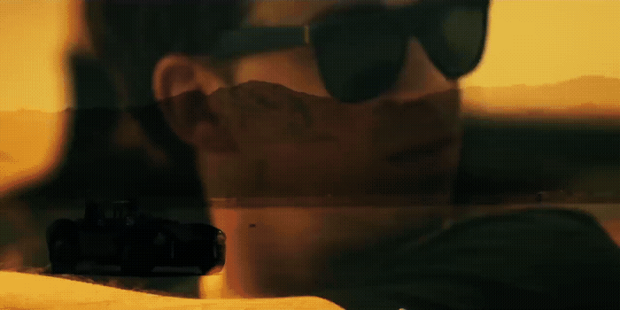 a reflection of a man wearing sunglasses in a mirror