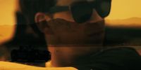 a reflection of a man wearing sunglasses in a mirror