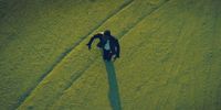 a man standing in the middle of a field