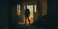 a man standing in a doorway of a building