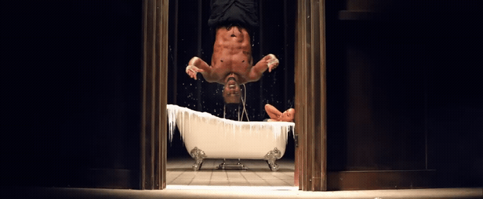 a man falling off of a bathtub in a bathroom