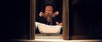 a man falling off of a bathtub in a bathroom