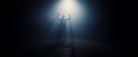 a person standing under a light in the dark