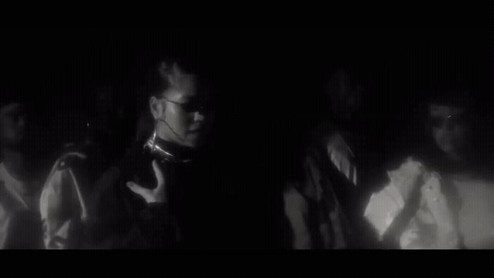 a group of people standing in a dark room