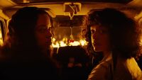 a couple of women sitting in the back of a car