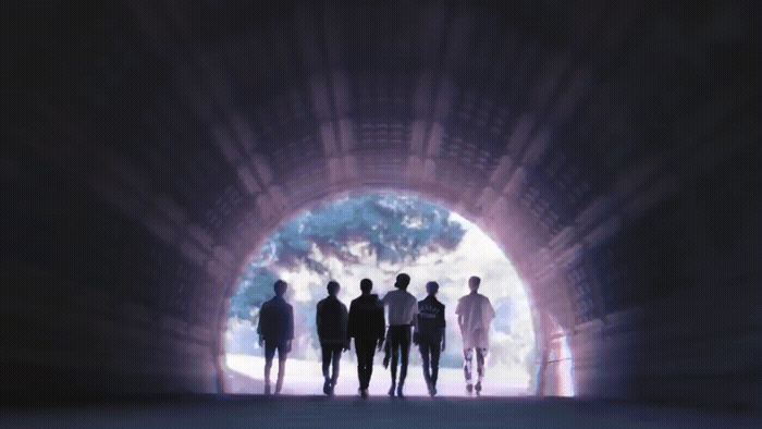 a group of people standing in a tunnel
