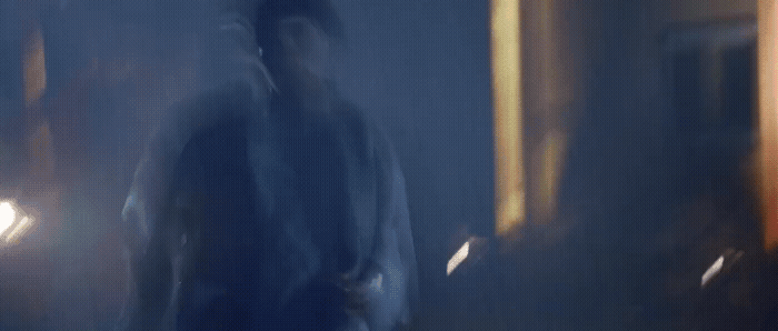 a blurry image of a man walking in a dark room