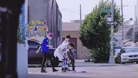 a group of young people standing on the side of a road