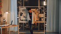 a man standing in front of a window in a room