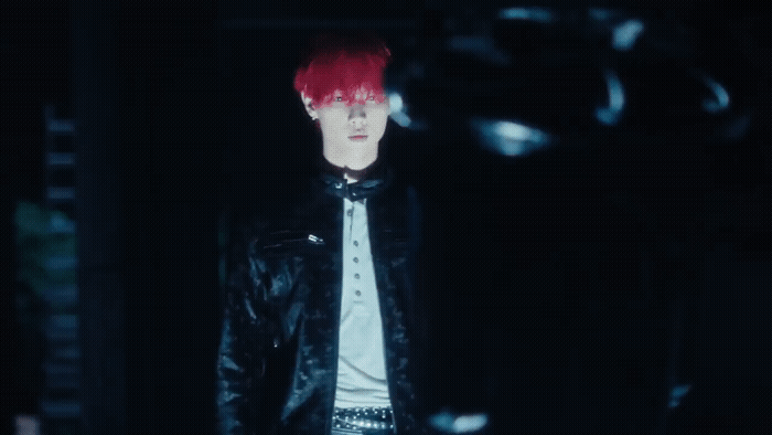 a man with red hair wearing a black leather jacket