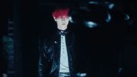 a man with red hair wearing a black leather jacket