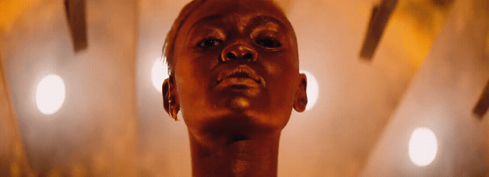 a close up of a person's head with lights in the background