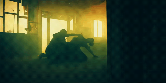 a man and a woman sitting in a dark room
