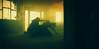 a man and a woman sitting in a dark room
