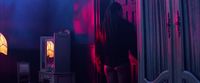 a person standing in a room with a lamp