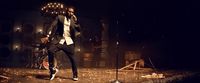 a man standing on a stage holding a microphone