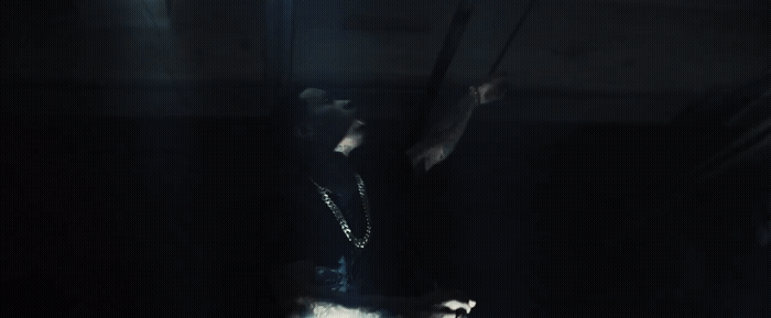 a person standing in a dark room with a light on