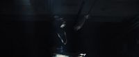 a person standing in a dark room with a light on