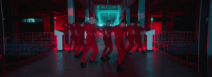 a group of people dressed in red dancing in a hallway