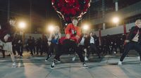 a group of young men and women dancing on a dance floor