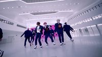 a group of young men dancing in a large room