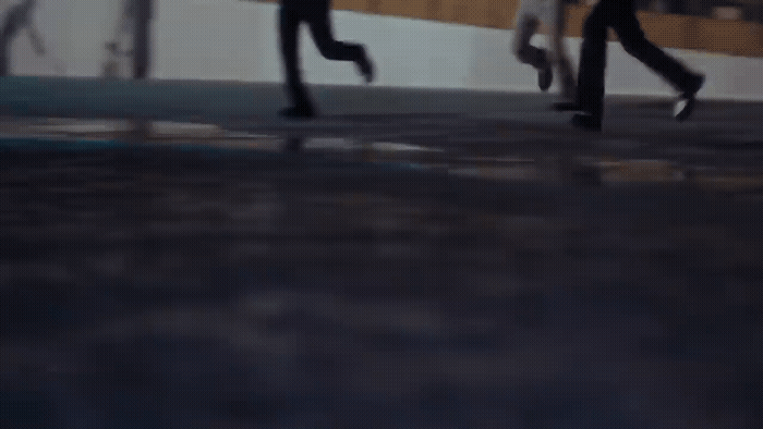 a couple of people that are walking down a street