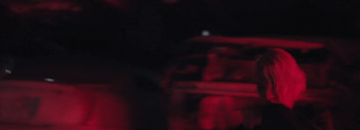 a blurry image of a person standing in the dark