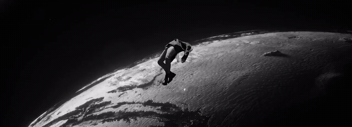 a black and white photo of a person on a surfboard