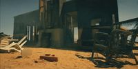 an old abandoned building sitting in the middle of a desert