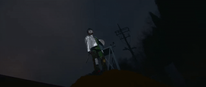 a man standing on top of a hill at night