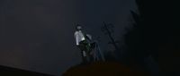 a man standing on top of a hill at night