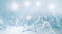 a group of people dancing in a foggy area