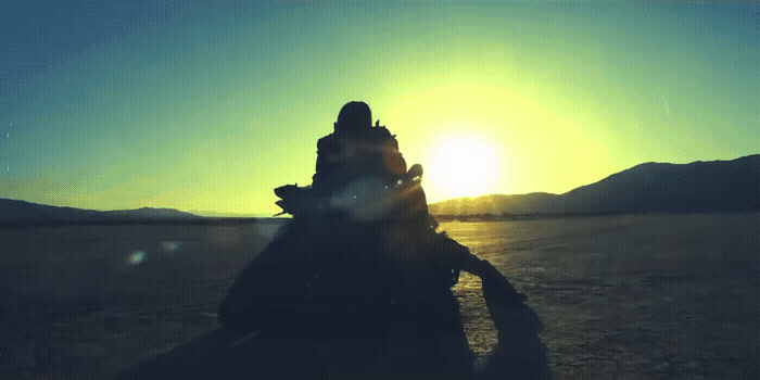 a person riding a motorcycle in the middle of a desert