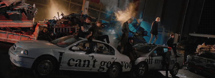 a group of people standing on top of a car