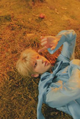 a little girl laying on the ground in a blue dress