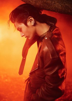 a woman wearing a leather jacket and ear piercings