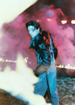 a man in a black leather jacket holding an umbrella