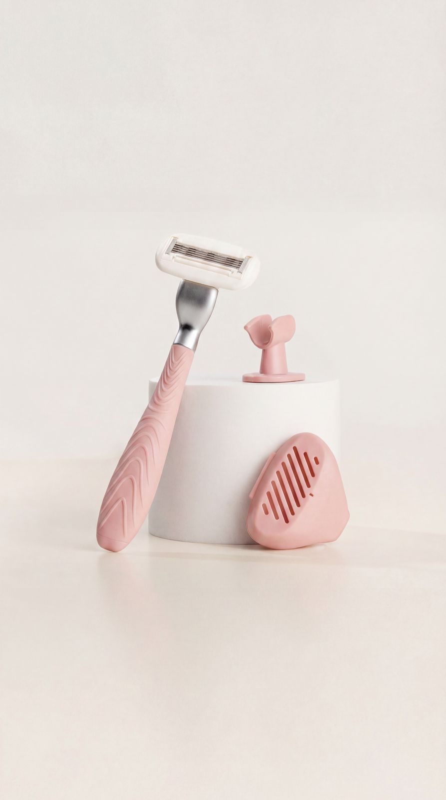 a pink and white toothbrush holder with a pink handle