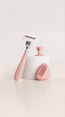 a pink and white toothbrush holder with a pink handle