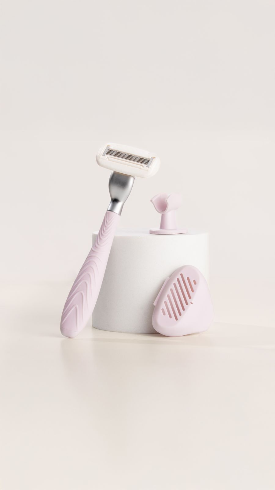 a toothbrush and a razor on a white surface