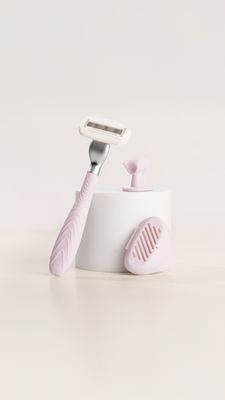 a toothbrush and a razor on a white surface