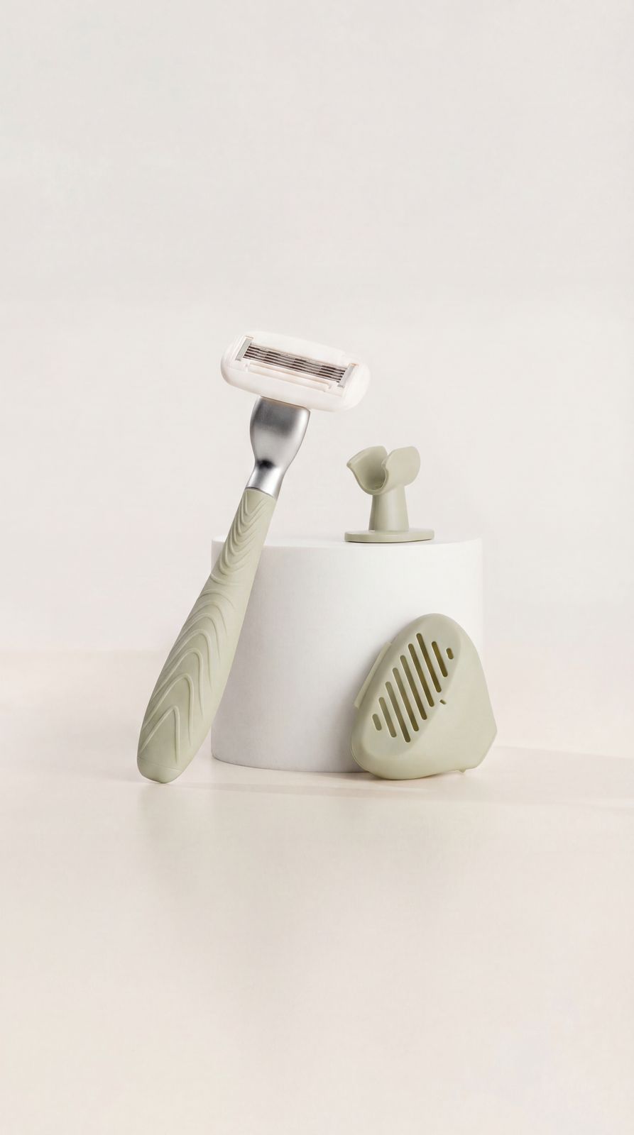 a toothbrush and a razor on a white surface
