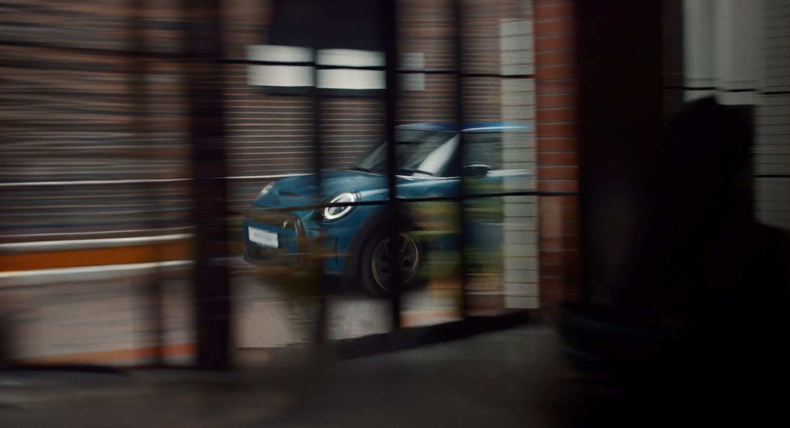 a blue car is seen through a window