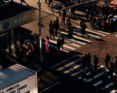 a group of people walking across a street