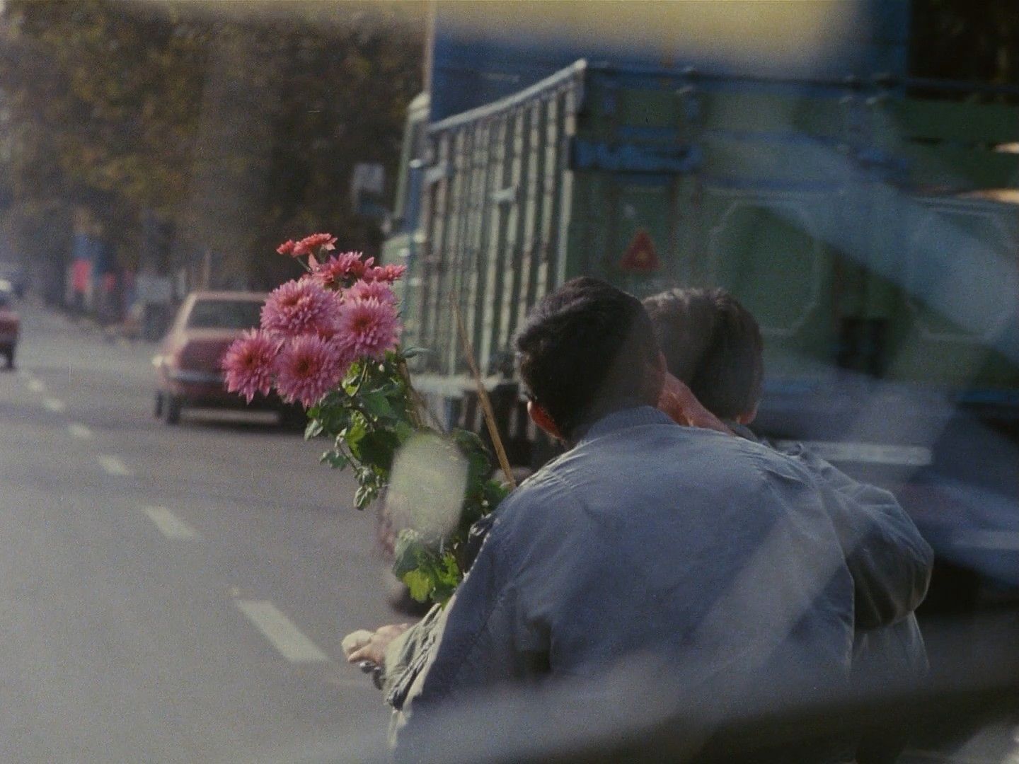 a man taking a picture of a bunch of flowers