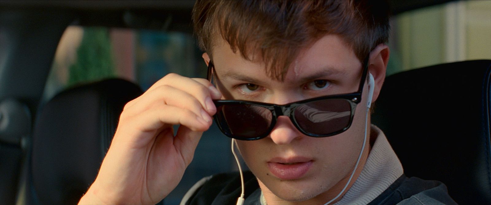 a young man wearing sunglasses and headphones